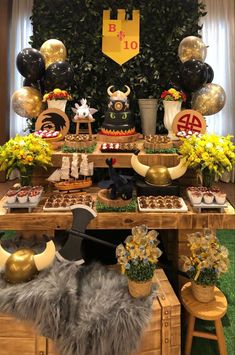 a table topped with lots of desserts and balloons