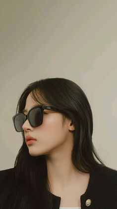 a woman with long black hair wearing sunglasses