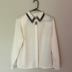 Gorgeous Vintage Women’s Blouse Button Down. With Beautiful Embroidery. P2p 20 Inches Size 8. Has Not Been Worn Before And In Brand New Condition! Feel Free To Check Out My Closet And Bundle To Save 10% Kind Offers Welcome! Collared Tops With Embroidered Cuffs For Work, Embroidered Collared Tops For Work, Workwear Blouse With Embroidered Cuffs, Embroidered Cuffs Blouse For Workwear, Elegant White Blouse With Striped Collar, Elegant Embroidered Tops For Work, Elegant Embroidered Workwear Tops, Elegant Collared Top With Floral Embroidery, Collared Floral Embroidery Top For Work