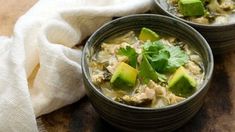 two bowls filled with chicken and avocado soup