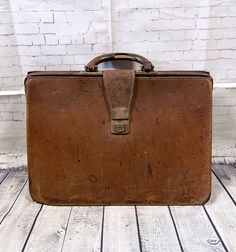 Original 1960s Vintage Tan Distressed Doctor's Bag/Briefcase Fantastic and character-filled original vintage doctors bag in rich tan brown leather. Four large internal compartments and a brass-tone push-lock closure. The original key is not attached but the case is unlocked and usable. Measures approx 17" x 12" x 6". The case is very well used and has many marks and scratches plus it leans a little. This adds character and the case is generally in good vintage condition and usable.   Measurement Vintage Satchel Bags For Work, Retro Vintage Brown Business Bag, Vintage Brown Office Bag, Vintage Rectangular Satchel For Business, Retro Satchel Briefcase For Office, Vintage Satchel Briefcase For Office, Retro Vintage Brown Satchel For Business, Vintage Brown Bags For Business, Vintage Rectangular Business Satchel