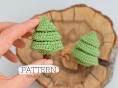 crochet christmas tree ornaments are being held in front of a wood slice with the word pattern on it