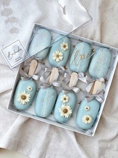 a box filled with blue and white decorated cookies