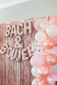 balloons and streamers are hanging from the wall in front of a backdrop that says bach & boulee