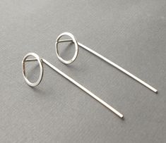 "These simple earrings are made using 18 gauge sterling silver wire with a small hoop that's been hammered flat and a long straight back giving these a unique minimalist look. They've been tumble polished for extra strength and shine. The hoop is about 1/2\" in diameter. The total length is just under 1 3/4\". The gauge I used for these is a bit thicker than standard ear wires but should fit most piercings comfortably. All items are placed in tissue paper and sent in a white jewelry gift box." Hammered Wire Jewelry, Modern Silver Earrings, Silversmithing Jewelry, Small Silver Hoop Earrings, Jewelry Wax, Wire Jewelery, Stick Earrings, Earrings Wire, Silver Jewelry Design