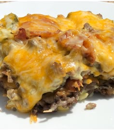 a close up of a plate of food with meat and cheese on it's surface