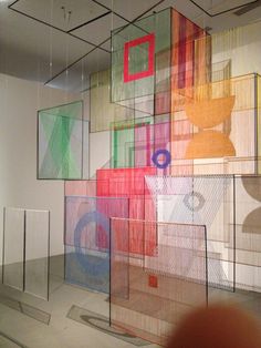 an art exhibit with many different colored squares on the wall