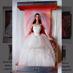 a barbie doll in a wedding dress with veil and tiara is shown inside a box