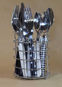 a metal basket filled with silverware and utensils