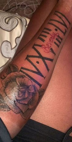 a person with a rose tattoo on their arm