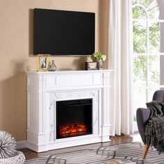 a living room with a fireplace, chair and television