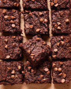 chocolate brownies cut into squares and placed on top of each other with chocolate chips