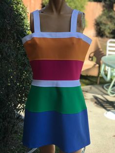 Here is the cutest vintage 1970s polyester tennis dress.Made by Number One Sun. Size 14.Following  are the measurements. Bust 38",waist 32",hips 46",Length 35".Zips up the back. Bright colorful fabric.In nice vintage condition Please take special consideration of measurements. 1970s sizing was very small to today's standards. Tennis dresses were very short not like a regular dress. So please take special note of length. If you live overseas please email me first before purchasing for mailing cost. Price quoted is for USA only 1970s Style Mini Summer Dress, Retro Multicolor Square Neck Dress, Retro Multicolor Lined Mini Dress, Retro Fitted Color Block Dress, 1970s Fitted Mini Dress, 1970s Style Fitted Mini Dress, 1970s Fitted Mini Dress For Summer, Fitted Multicolor 1970s Style Dresses, Fitted Multicolor 1970s Dresses