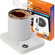 a white coffee mug sitting on top of a warmer