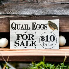 a sign for quail eggs is displayed on a shelf