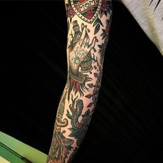 a man with tattoos on his arm and leg