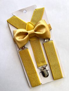 "Size 6m-2yo: adjustable elastic  suspenders run from 16\"- 25\" long, bow tie's neck strap is about 14\" long; (adjustable), velcro closure Size 3yo-5yo: adjustable elastic suspenders run from 16\"-25\" long, bow tie's neck strap is about 15\" long; (adjustable), velcro closure Size 6yo-12yo: adjustable elastic suspenders run from 21\"-34\" long, bow tie's neck strap is about 16 1/2\" long; (adjustable), velcro closure Size adult up to 5'6\": adjustable elastic suspenders run from 25\"-40\" lon Adjustable Gold Bow Tie As A Gift, Adjustable Gold Satin Bow Tie, Fitted Belts And Suspenders With Bow For Party, Adjustable Gold Bow Tie For Party, Adjustable Gold Bow For Party, Gold Suspenders, Gold Bow Tie, Long Bow, Suspenders Set