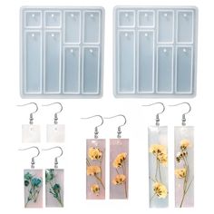 three plastic trays with flowers on them and hanging from the hooks in front of them