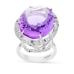 Exuding pure elegance, you'll stand out in a crowd with this romantic, feminine, luxurious designer jewelry piece. This stunning cocktail ring is crafted in 18K white gold,  showcasing an oval royal purple amethyst mounted in a six prong setting and wrapped in a gorgeous embellished diamond pave halo. The center stone sits on a white gold band in a cathedral setting featuring sparkling miniature diamond adorned filigree detailing. Surprise your loved Luxury Hallmarked Amethyst Ring For Formal Occasions, Luxury Purple Jewelry With Halo Detail, Luxury High Luster Purple Jewelry, Luxury Purple Rose Cut Diamond Jewelry, Luxury White Gold Amethyst Ring With Gemstone Accents, Luxury Purple Platinum Rings, Luxury Purple Amethyst Ring With Halo Setting, Luxury Amethyst Ring With Prong Setting, Luxury Amethyst Ring With Halo Setting