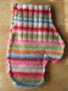 a pair of colorful socks sitting on top of a wooden table