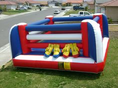 an inflatable bounce house with yellow shoes on it