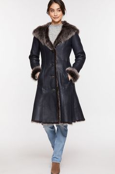 We fashioned winter warmth into a long, elegant coat that surrounds you in elegance. The Theodora, crafted from premium Spanish Toscana sheepskin, boasts a navy brisa exterior and plush interior. Feel the luxuriousness and loft of Toscana sheepskin at the hemline, cuffs, collar, and generously sized hood and enjoy the supreme insulation it offers. Nicely shaped with a defined waistline and feminine flared hem, this warm, button-front coat makes a grand showing wherever you wear it. With two fron Shearling Long Fur Coat For Cold Weather, Long Shearling Fur Coat For Cold Weather, Shearling Long Coat For Cold Weather, Classic Sheepskin Fur Coat For Winter, Classic Sheepskin Coat With Faux Fur Trim, Classic Sheepskin Fur Coat With Faux Fur Trim, Long Sheepskin Coat In Mink Color, Sheepskin Long Coat In Mink Color, Sheepskin Long Coat For Cold Weather