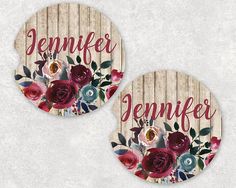 two coasters with flowers and the words, demiffer written in red on them