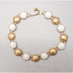 This is part of Chairish’s Costume Jewelry assortment.  1950s goldtone round textured sections and white cabochon rhinestone sections collar necklace with hook clasp. Marked "Napier" on the hook. Center:  7/8 inches across. Interior circumference about 16 3/4 inches. Condition: Very good; some tiny dark spots to goldtone minor discoloration to white sections, may come off with cleaning; nothing real noticeable. A goldtone only version of this necklace is shown on pg. 235 of Melinda L. Lewis & He Retro White Round Jewelry, Hook Clasp, Accessories Jewelry Necklace, White Collar, Collar Necklace, Dark Spots, Vintage 1950s, Vintage Necklace, Costume Jewelry