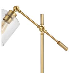 a gold table lamp with a clear glass shade on the top and bottom part of it