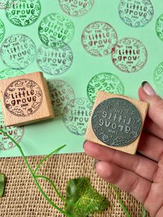 two rubber stamps with the words little love on them are shown in front of a green background