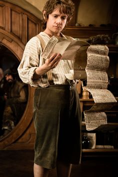 a man standing in front of stacks of papers