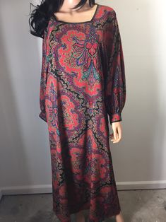 "Vintage boho chic caftan dress gown by R Michael Alan.  Red paisley design with red, black, blue and gold colors.  Long sleeves are wide and have button closures at the hems and dress has pockets.  Made in Philippines.  100% polyester, soft to the touch.  No shoulder pads. Rare and hard to find designer item.   Note there there is one \"S\" tag and another \"M\" tag.  Also, when I was trying to read the materials tag for the photos, it separated from the dress.  I have it clipped for now to include with the dress.  The model shown is 5'9 and slim.   Length (shoulder to bottom hem): appx 53.5\" Pit to pit:  appx 19.5\" across Back of neck to sleeve:  appx 29.5 Pit to sleeve:  appx 19.5\" Bottom hem:  appx 31\" across" Red Bohemian Maxi Dress With Paisley Print, Red Bohemian Maxi Length Abaya, Boho Paisley, Red Paisley, Dress Long Sleeves, Gold Colors, Caftan Dress, Dress Gown, Paisley Design