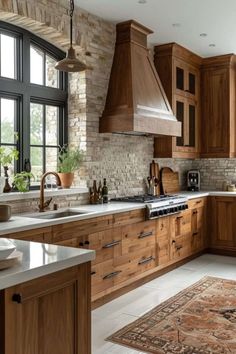 a kitchen filled with lots of wooden cabinets and counter top space next to a window