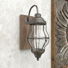 an old fashioned lantern hanging on the wall