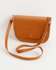 Key Features



Versatile and stylish: Thoughtfully crafted from certified vegan leather in classic tan, combining timeless style with ethical sourcing.


Spacious interior: Ample room to organize all essentials, making it ideal for daily use and travel.


Secure and functional: Features include an adjustable cross-body strap, a zipped inner pocket, and a magnetic fastening for easy access and security.


Durable construction: Designed to endure everyday wear and maintain its elegant appearan Rectangular Dark Tan Shoulder Bag For Travel, Versatile Saddle Bag With Detachable Strap For Travel, Classic Soft Leather Saddle Bag For On-the-go, Timeless Everyday Saddle Bag With Adjustable Strap, Timeless Saddle Bag With Adjustable Strap For Everyday, Timeless Everyday Flap Bag With Adjustable Strap, Classic Faux Leather Everyday Bag, Travel Shoulder Bag With Removable Pouch In Dark Tan, Everyday Saddle Bag With Detachable Strap