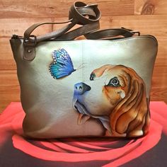 a purse with a dog and butterfly on it