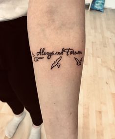 a person with a tattoo on their leg that says always and forever in cursive writing