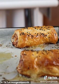 there are two pieces of bread on the baking sheet, and one is half eaten