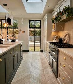 a kitchen with an oven, stove and sink in it's center island area