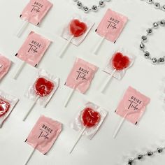 candy lollipops with price tags on them sitting on a white tablecloth