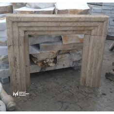 a stone fireplace surround in the middle of a pile of bricks