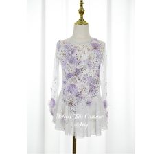 a dress on a mannequin with purple flowers and sequins in it