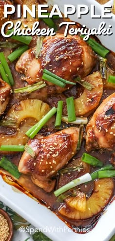 pineapple chicken teriyaki in a white casserole dish with green onions