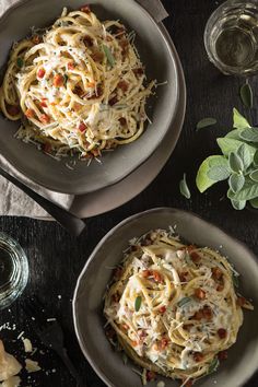 two bowls filled with pasta on top of a table