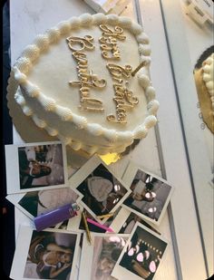 a birthday cake sitting on top of a table next to pictures and pens with the words happy birthday written on it