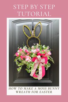 an easter wreath with pink flowers and bunny ears hanging on the front door to make a moss bunny wreath for easter