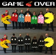 some people are holding up paper pacman and pac man costumes that say game over