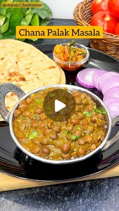 chana palak masala is served on a black plate