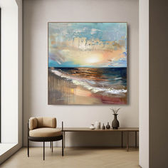 an abstract painting hangs on the wall above a chair and table in a living room