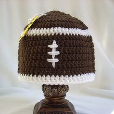 a crocheted football hat on top of a lamp